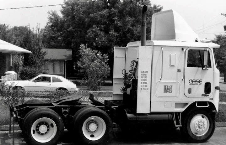Black and white side view of a historical Case Enterprises truck